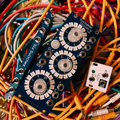 The following three modules are placed on a bed of patch cables: Eucidean Circles V3, Six Switches and Passive LPG