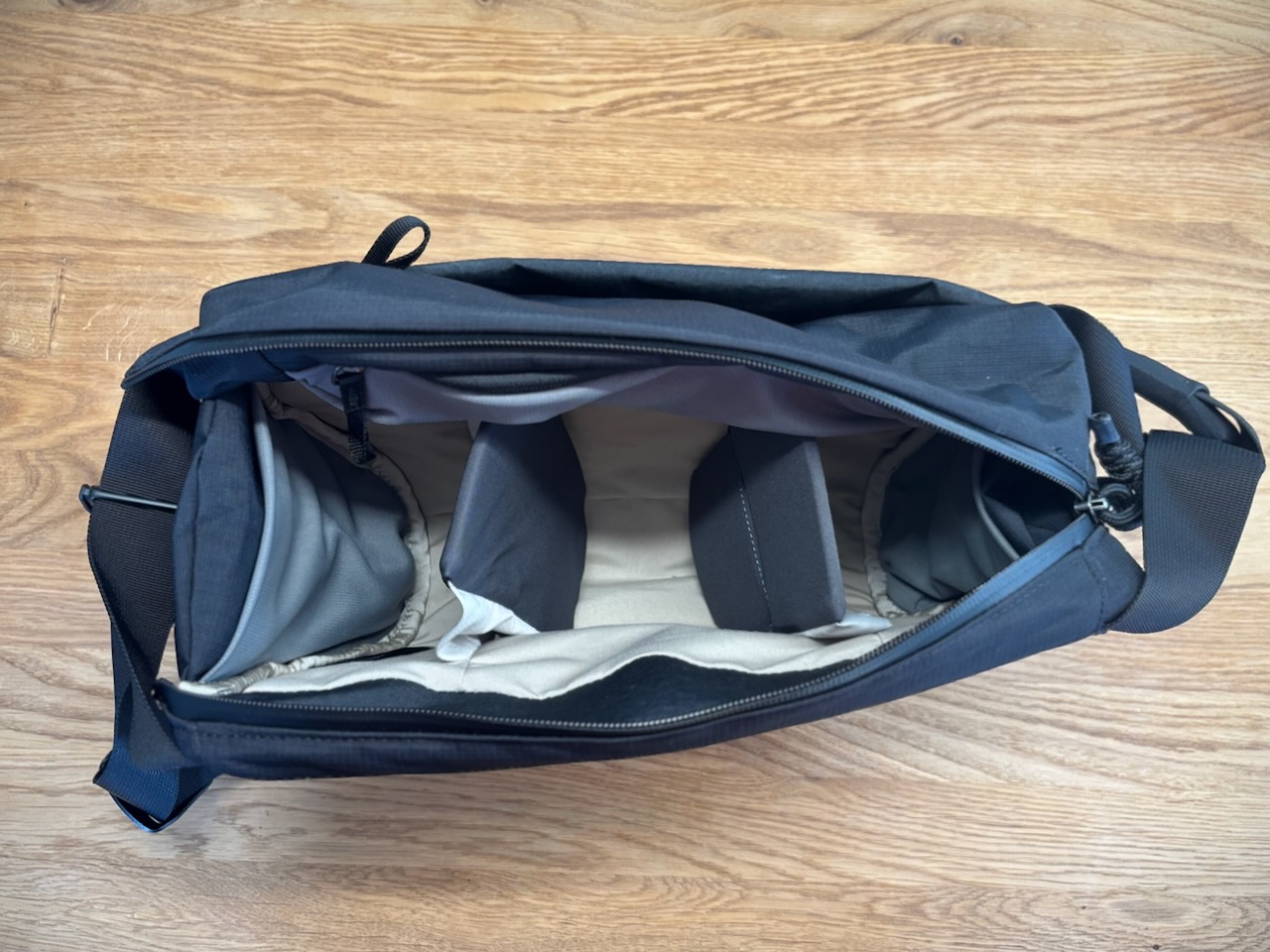 Top view of an empty Bellroy Venture Camera Mag showing two padded fixed dividers creating three compartments inside the main pocket.
