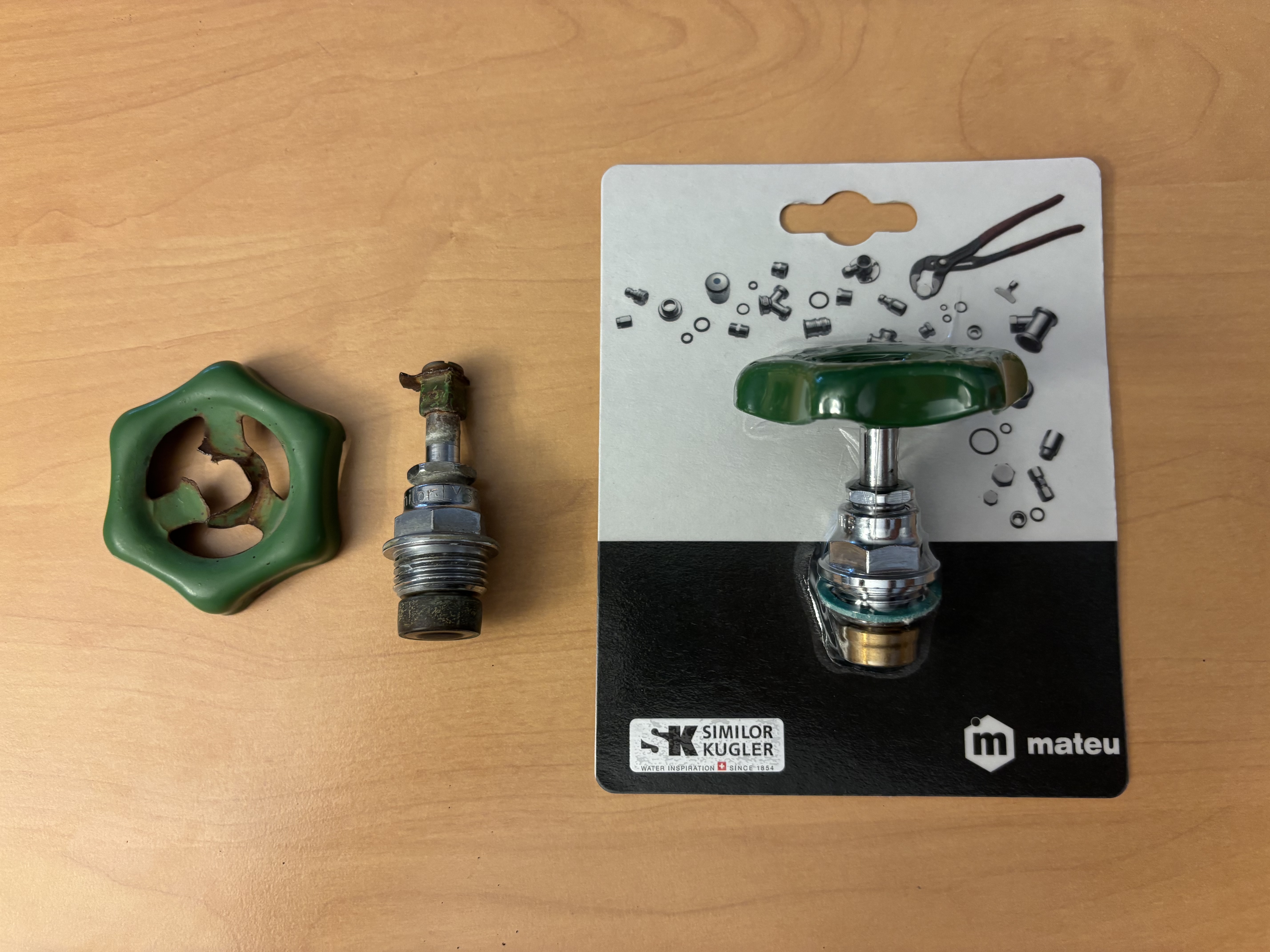 A broken green garden tap handle and its corroded valve stem next to a new packaged Similor Kugler replacement part.