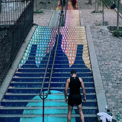 The stairs of Montmartre decorated with a sportsman who is about to run up them