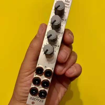 A hand holding a white Doepfer mixer module against a yellow background, displaying four rotary knobs at the top labeled with mix levels and six black input jacks at the bottom.