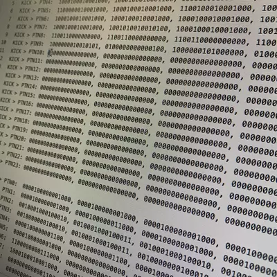 Terminal output displaying hexadecimal and binary code sequences, showing multiple lines of machine-readable data with patterns of 1s and 0s interspersed with hexadecimal values, representing low-level programming or drum machine data processing.