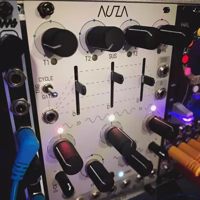NUTA synthesizer module with three knobs labeled T1, T2, and SUS at the top, a CYCLE section with GATE control on the left side, and six black faders arranged in two rows at the bottom, with blue and red indicator lights illuminated throughout the white panel.