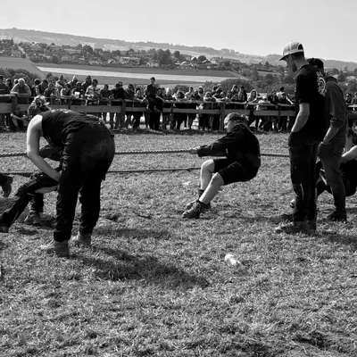 A tug-of-war team. They are cheered on by members of their youth