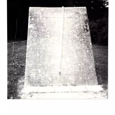 Concrete obstacle from the NATO training course at Moudon military barracks, featuring a rectangular opening structure, black and white Polaroid photograph
