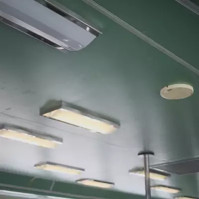 Interior ceiling of a Venice vaporetto ferry, green panelling with rows of fluorescent strip lights