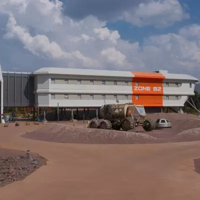 A theme park attraction building painted white with a bright orange 