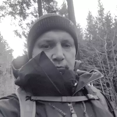 A selfie of me wearing a lot of layers and a beanie