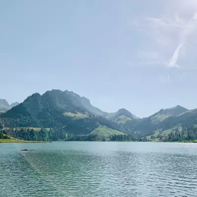 Photo prise depuis la plage du lac noir. En bas de la photo en premier plan, on voit le lac. On va deuxième plan se trouve la chaine de montage du Ripa.