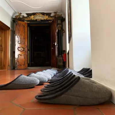 The slippers waiting for visitors in front of the library entrance. It is mandatory to wear them to enter the library.