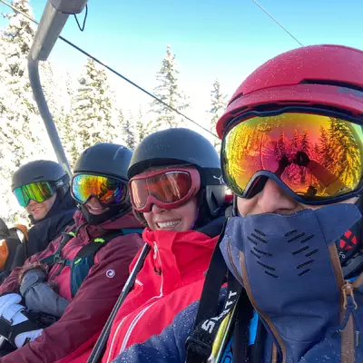 from left to right, Cédric, Coralie, Céline and Laurent sitting on a chairlift